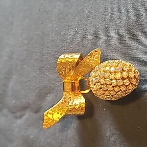 Bow gold tone and rhinestone egg brooch